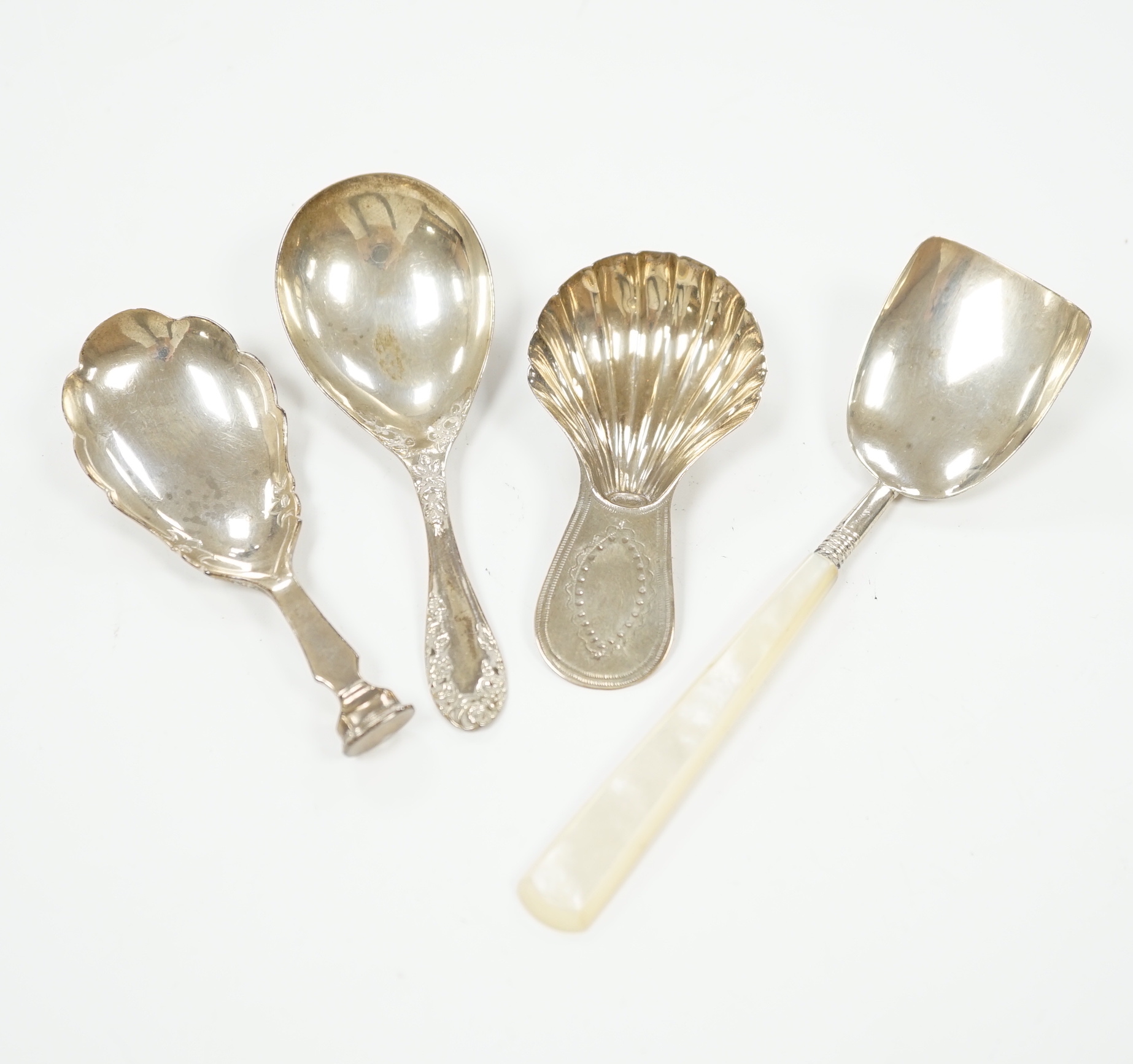 Two 19th century silver caddy spoons including mother of pearl handled by George Unite, 12.1cm and two later silver caddy spoons.